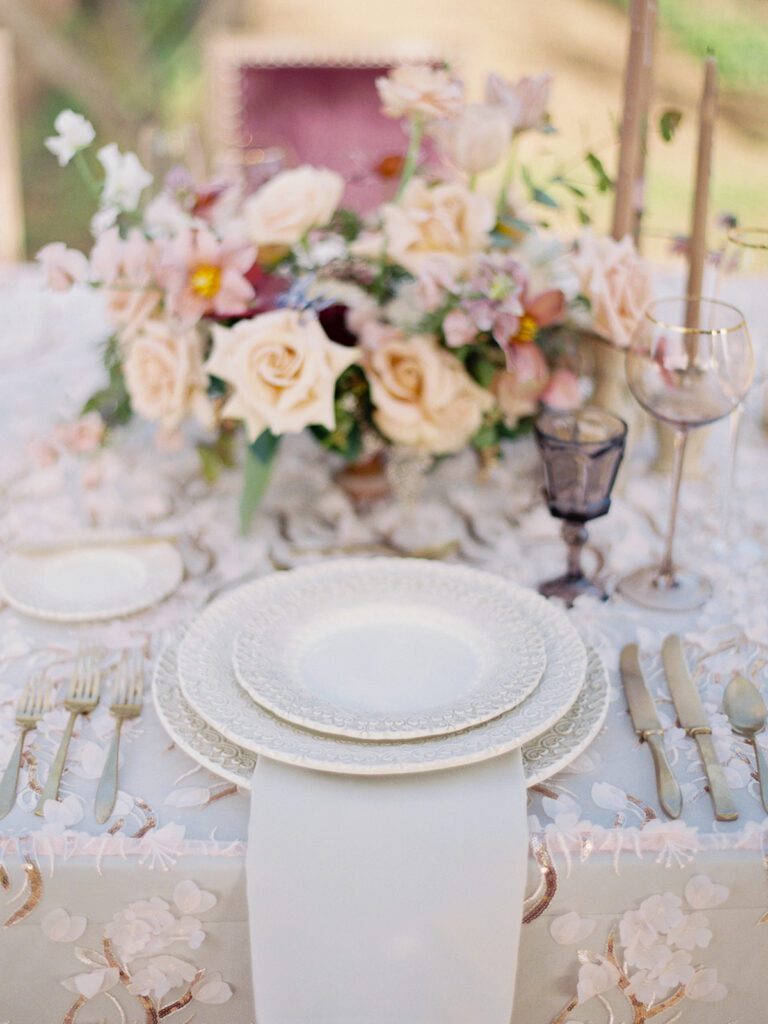Reception table with floral design at a Sunstone Winery wedding, Santa Ynez, California.